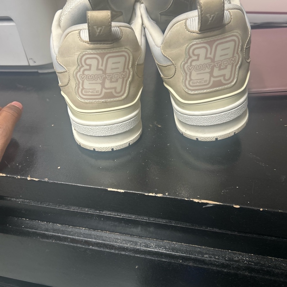 Cream colored Louis Vuitton trainers